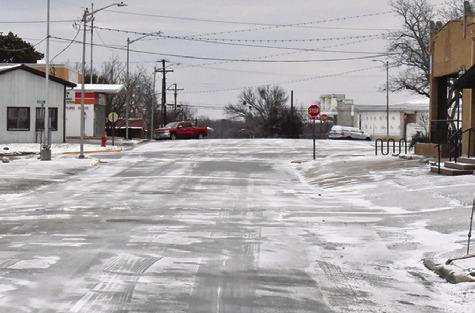 STREETS IN DOWNTOWN CALDWELL were covered in snow after the county received a little under an inch of the white powdery stuff. Tribune photo by Roy Sanders