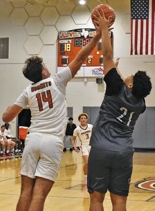 JOHN FRYREAR OF Caldwell reaches high for this rebound against Bryan JV. Tribune photo by Roy Sanders