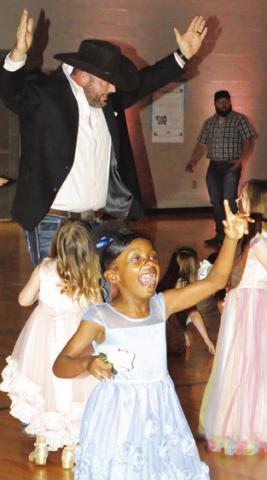 DADDY’S AND THEIR little princesses enjoyed Friday night’s “Daddy Daughter Dance” in the Snook Elementary School. Tribune photo by Denise Squier