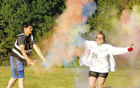 THIS RACE PARTICIPANT IN “Debbie’s 5K Color Walk” enjoyed the color shower at this race point. The event was hosted by the Pena Brothers Memorial at Davidson Creek Park on Saturday. Tribune photo by Denise Squier