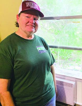 CERT MEMBER Deanie Gold installed a window air conditioning unit in a home in Tunis last weekend. CERT is raising money to install more AC units into homes needing cooling.