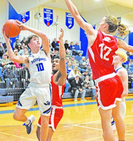 LANCE LARA OF Snook jumps high for this shot despite some defensive pressure from Burton. -- Tribune photo by Roy Sanders