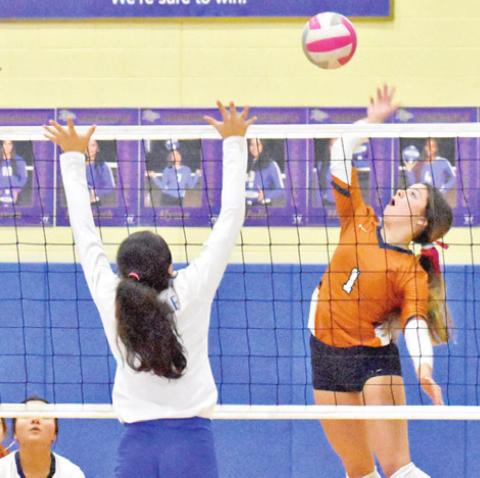 CALDWELL’S ASHLYN KELLUM reaches to hit the ball for one of her 20 kills against Rockdale last Friday. -- Tribune photo by Roy Sanders