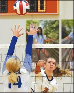 CALDWELL’S DELAYNI Drgac hits the ball over Snook’s Jalee Baumann during the Lady Hornet-Lady Jay battle on Friday.