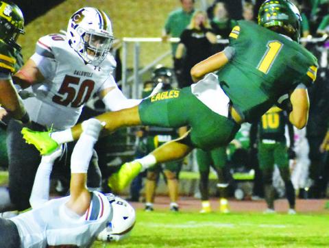 JAXON ANDERSON OF CALDWELL makes this tackle last Friday against Lexington in the Hornets’ final non-district game. Also pictured is Caldwell’s Davian Sanchez. Tribune photo by Roy Sanders