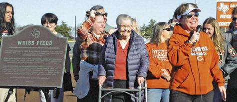 LONGTIME LADY HORNET softball coach Wendy Weiss thanks the community for honoring her by renaming the softball field “Weiss Field.” Her family also attended the ceremony. Tribune photo by Denise Squier