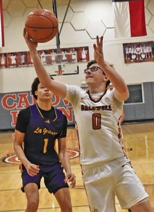 CAYDEN ZBORIL reaches for the ball last Friday against La Grange. Tribune photo by Roy Sanders