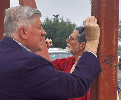 MEMBERS OF NEW Tabor Brethren Church wrote scriptures on the frames of the new building last Sunday.