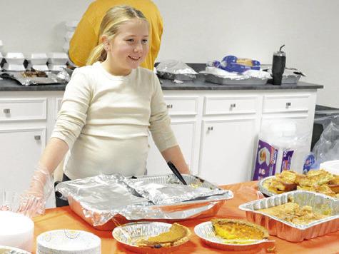 ON DESSERT DUTY! Members of all ages from Caldwell Assembly were serving the community at the church’s Thanksgiving meal. Tribune photo by Denise Squier
