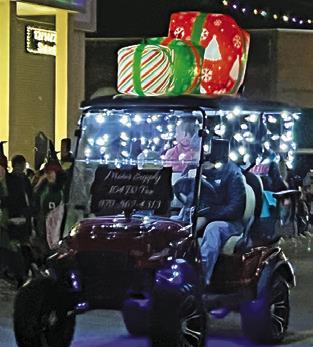 VEHICLES ADORNED with Christmas lights and decorations were part of the Lighted Christmas Parade during last Friday’s “Christmas on the Square.” See story inside. Tribune photo by Denise Squier