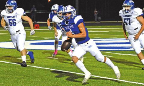 GARRETT LERO CARRIES the ball against Bartlett. The Snook Bluejays won 56-8. -- Tribune photo by Roy Sanders