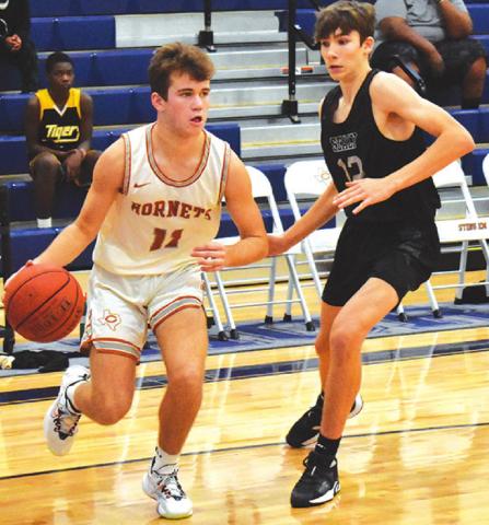 CALDWELL’S JAMIN White dribbles the ball past this Sealy defender on Friday.