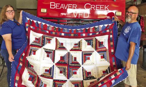THE CREATIVE MEMORIES QUILT GUILD donated a beautiful quilt to the Beaver Creek Fire Department in Caldwell. Holding the quilt are William Marquez, fire chief and Rebecca Prince. The fire department will use the quilt in their next fundraiser. The Creative Memories Quilt Guild meets on the fourth Wednesday of the month at 9:30 a.m. at the Caldwell Methodist Church on Fox Street. New members are welcome. Photo courtesy of the Creative Memories Quilt Guild