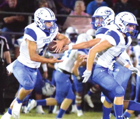 SNOOK’S J. BEAUX HRUSKA hands off to Garrett Lero while Garrett Hyvl looks to block during the Bluejays’ win over Somerville last Friday night at The Rock in Somerville. -- Tribune photo by Denise Squier