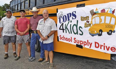 HELPING WITH the Cops 4Kids School Supply Drive on Monday, Aug. 10, were, from left, Michael Hester, Wyatt Hester, Burleson County Sheriff Bill Rios and Peter Glidewell. The annual drive is also sponsored by Texas A&amp;M AgriLife Extension Service.