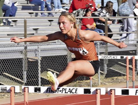 CALDWELL’S KAYLAN GROCE clears this hurdle during last week’s Happy Skrabanek Relays at Hornet Stadium. Tribune photo by Roy Sanders