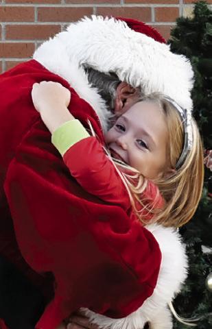 SANTA OFFERS A warm hug at the Snook Education Foundation’s Bluejay Trail of Lights last Friday in Snook.