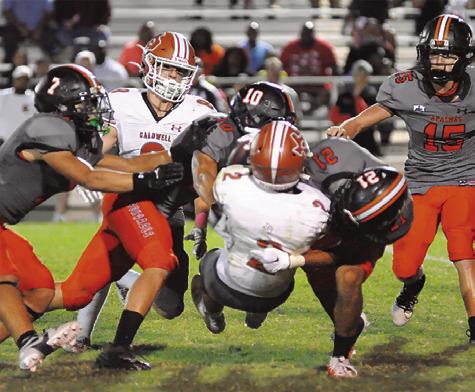 BLANE GARZA OF Caldwell is tackled by Gonzales defenders.