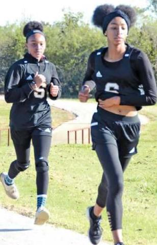 SOMERVILLE’S DESTINY Vela and Ra’Maya Carter run during the girls two-mile race at the District 26-2A Cross Country Meet. Vela won the girls title, and Carter placed fourth.