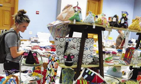 VISITORS TO THE CREATIVE Memories Quilt Guild show shopped in the guild’s Country Store -- filled with fabrics, crafts, pattern books and quilted items for sale -- at the Caldwell Civic Center. Tribune photo by Denise Squier