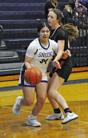 ASHLEY QUEVEDO dribbles around a Smithville player during the Snook-Smithville game last Tuesday afternoon in Snook. Tribune photo by Denise Squier