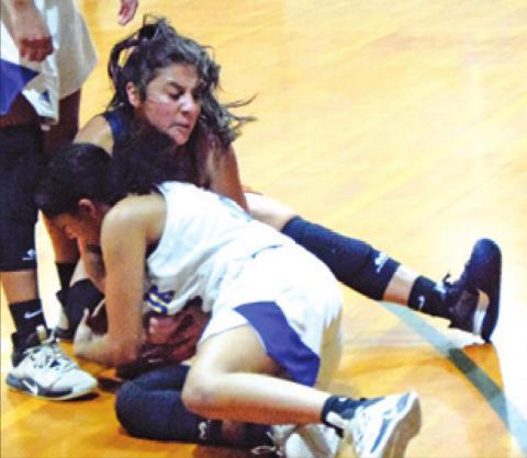ANDREA FLORES fights with a Dime Box player for possession of the ball during Caldwell’s game against the Lady Horns last Thursday. -- Tribune photo by Denise Squier