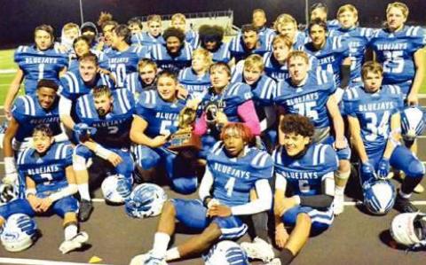 THE SNOOK BLUEJAYS celebrate with their championship trophy