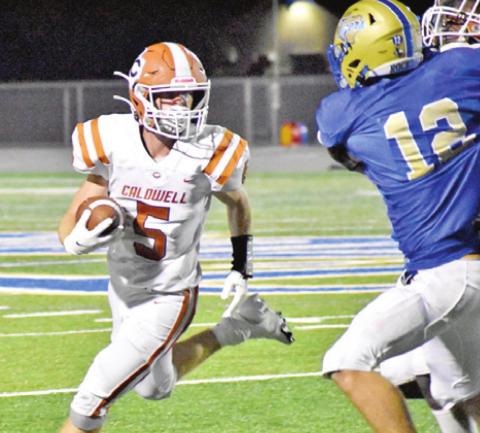 CALDWELL’S JACE ALY carries the ball against Rockdale. The Hornets lost 34-30 in Rockdale. -- Tribune photo by Roy Sanders