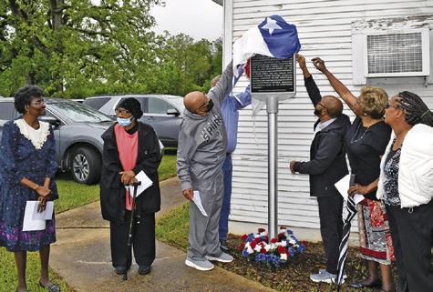 CHURCH MEMBERS UNVEIL the marker on Saturday. They include, from left, Wilma Hanks, Hazel Bryant, Melvin Morris, Hubert Morris Jr., Ruthie Pollard Ellison and Grace Wilson. Tribune photo by Roy Sanders