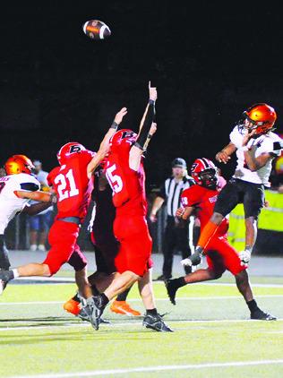 HERSCHEL CONWAY THROWS THIS pass against Burton. Also pictured is DeChristian Deere. -- Tribune photo by Denise Squier