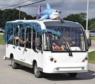 THIS WELL DECORATED bus is part of the Saturday morning parade in Somerville during the Crater Motorcycle Rally.