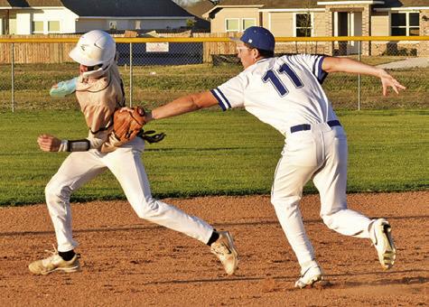 ALBERTO NORWOOD OF Snook tags this Bellville Faith Academy base runner on Friday in Snook. The Bluejays lost 12-1. Tribune photo by Roy Sanders