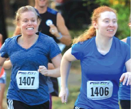 MOTHER-DAUGHTER RUNNING DUO, Tonya and Serena Foster of Caldwell, won each of their divisions during Saturday’s Kolache Krunch 5K. Tonya won the Female 45-49 division, and Serena won the Female 20-24 division. -- Photo courtesy of Andrew Wolfe Photography
