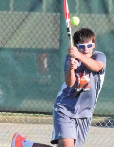 CONNOR HUGHSON returns serve during his boys’ doubles match with partner Waylon Chapman. -- Tribune photo by Denise Squier