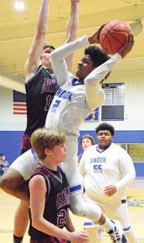 JERMAINE KEARNEY leaps to attempt a basket during the Bluejays’ game against Iola on Tuesday. -- Tribune photo by Denise Hornaday