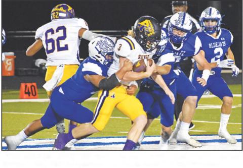 THE SNOOK DEFENSE moves in for a tackle last Friday against Runge in the district opener. — Tribune photo by Roy Sanders