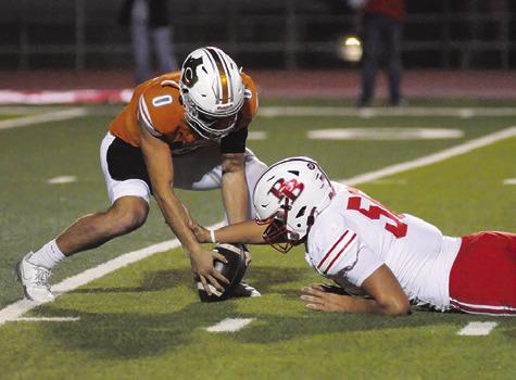 COY BECKA OF Caldwell reaches for this loose ball against Bellville. Tribune photo by Denise Squier