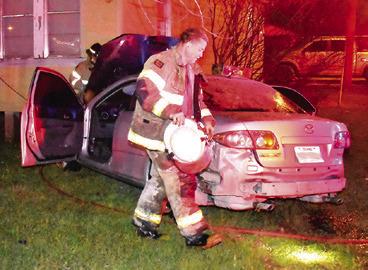 CALDWELL FIRE CHIEF David Pevehouse works at this Monday morning accident off Temple Street near the State Highway 21 intersection. No information on the accident was available at press time.