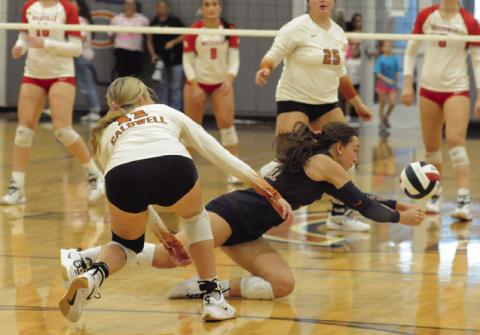 CALDWELL LIBERO NATALIE EASTEPP dives for the ball during the Caldwell-Bellville match on Friday. Also pictured are, Reese McManus and Kierstyn Macik. Tribune photo by Denise Squier
