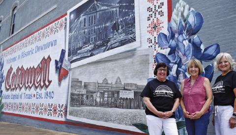 LIA ZACCAGNINO, BETSY WELHAUSEN and Janice Easter stand in front of this mural. Tribune photo by Roy Sanders