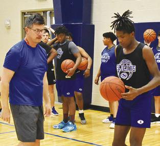 MARK MINATREA, Snook’s new head basketball coach, offers instruction at the Bluejays’ Monday practice session.