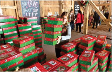 A VOLUNTEER FOR Operation Christmas Child moves boxes. These boxes will be distributed to children in need this holiday season. Photo courtesy of Hannah Murphy