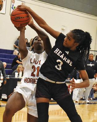 MESHA JOHNSON attempts a layup while a Hearne player defends during the annual Lady Hornet Classic last week. Tribune photo by Roy Sanders