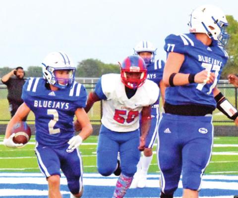LANCE LARA OF Snook carries the ball for Snook as teammate David Toler blocks. -- Tribune photo by Bailey Brown.