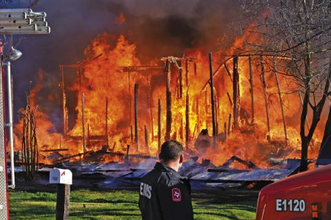 THE HOUSE AT 508 N. Hill Street burns as firefighters respond on Sunday morning. The house and contents were a total loss. -- Tribune photo by Roy Sanders