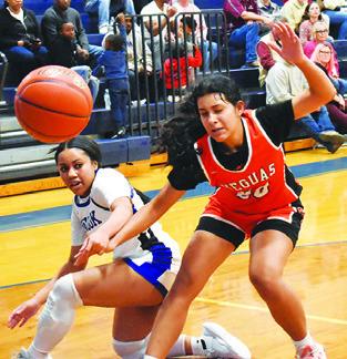 ALANA STRINGFELLOW and Annette Reyna fight for possession of the ball during the Snook-Somerville game last Friday in Snook. Tribune photo by Roy Sanders