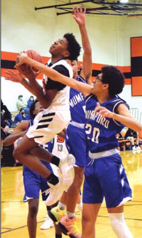 BRANDYN CARTER is fouled by Mumford’s Desmond Gamble while trying to shoot the ball during the Somerville-Mumford game last Tuesday. -- Tribune photo by Denise Squier