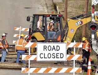 CREWS FROM Union Pacific Railroad work on the tracks last Friday on Harvey Street.
