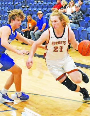 HARRISON NOVAK of Caldwell dribbles the ball as Caden Schluens defends for Snook.
