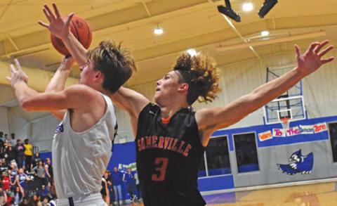 SNOOK’S SAM SMITHERMAN takes a shot as Somerville’s Johnny Legg defends. Snook on 70-51. -- Tribune photo by Roy Sanders